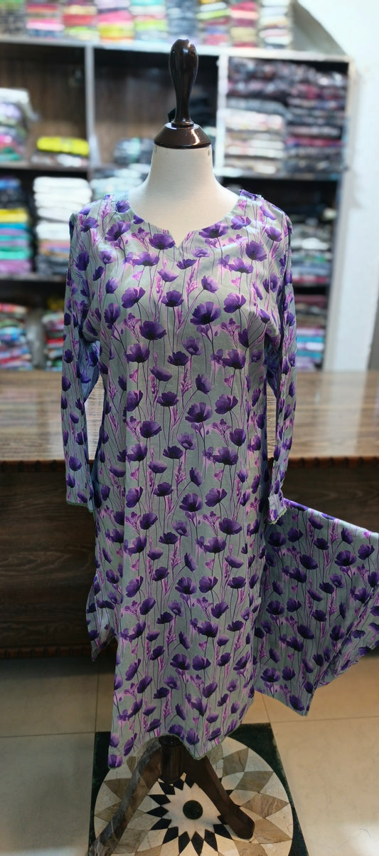 Mannequin wearing a long-sleeve dress with a purple floral pattern in a store setting.